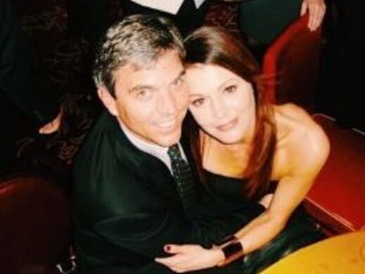 Marshall Coben and Jane Leeves are dressed in black, hugging each other.